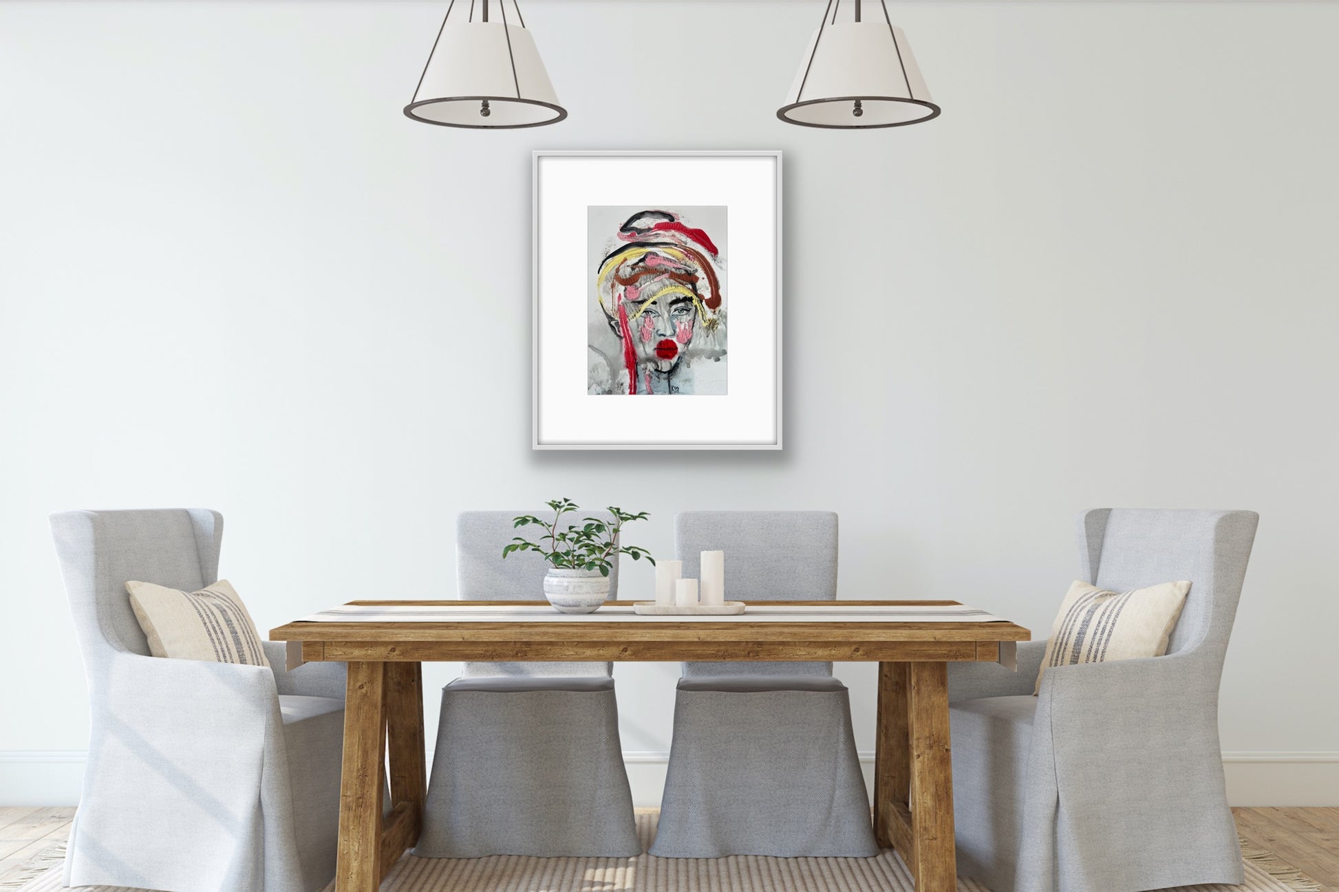 Dining room with wooden table and gray chairs, framed artwork on the wall.