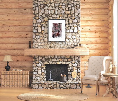Living room with stone fireplace, wicker basket, and armchair.