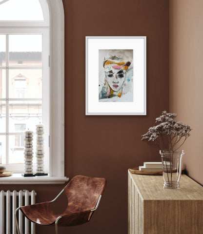 Modern interior with a framed artwork on a brown wall, a leather chair, and a wooden side table with a vase.
