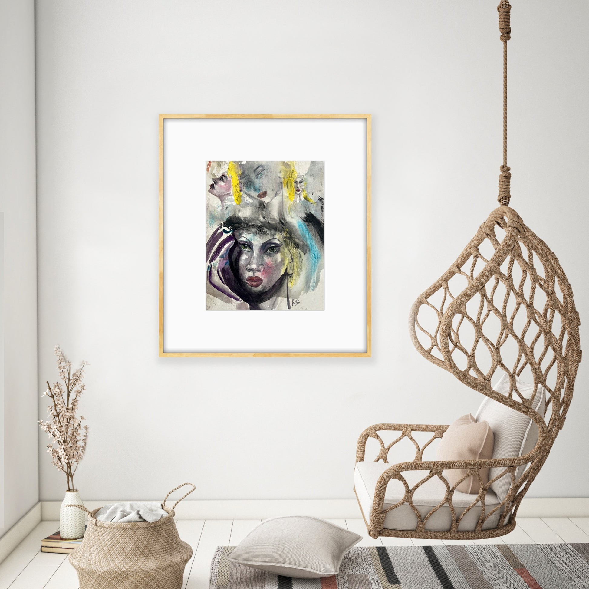 Light wood framed watercolor art displayed in a cozy room with a hanging macrame swing chair and natural decor.