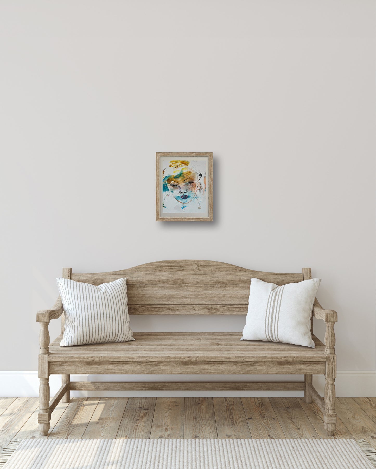Original acrylic painting Silence framed and hung on a wall above a wooden bench in a light Scandinavian-style entryway