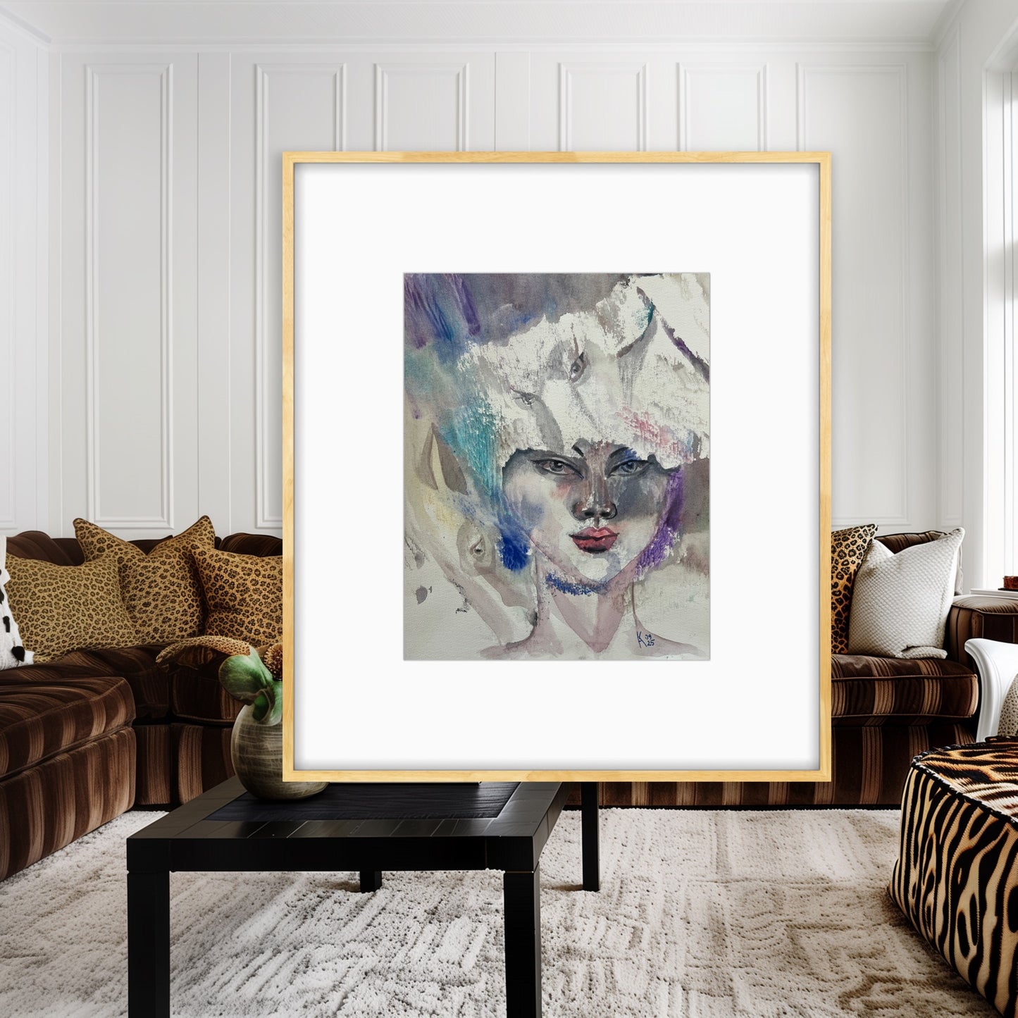 White Reverie original watercolor portrait painting in a gold frame displayed in a living room with brown velvet sofas