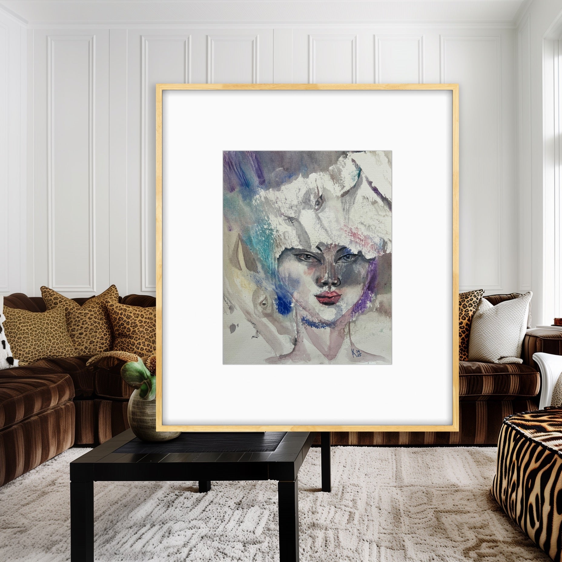 White Reverie original watercolor portrait painting in a gold frame displayed in a living room with brown velvet sofas