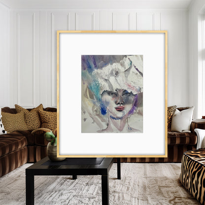 White Reverie original watercolor portrait painting in a gold frame displayed in a living room with brown velvet sofas
